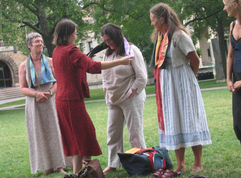 Vanessa Gilbert gives Jill Greenhalgh a scarf at the Magdalena USA festival in 2005, watched by Gilly Adams and Julia Varley